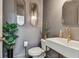 Stylish powder room with gold fixtures, gray walls, elegant mirror and modern vessel sink at 4610 W Browning Ave, Tampa, FL 33629
