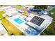 This aerial view shows the community pool, clubhouse, and other neighborhood amenities at 5538 Antigua Dr, Zephyrhills, FL 33541