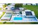 Aerial view of a community pool, shuffleboard, and common space with solar panels at 5538 Antigua Dr, Zephyrhills, FL 33541