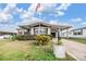Charming single-story home featuring a covered parking area and well-maintained landscaping at 5538 Antigua Dr, Zephyrhills, FL 33541