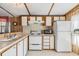 Efficient kitchen with white appliances and ample cabinet storage for cooking essentials at 5538 Antigua Dr, Zephyrhills, FL 33541