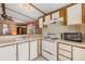 Functional kitchen featuring light-colored cabinets, essential appliances, and a practical layout at 5538 Antigua Dr, Zephyrhills, FL 33541