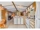 Bright kitchen featuring white appliances, wood-look cabinets, and plenty of counter space at 5538 Antigua Dr, Zephyrhills, FL 33541