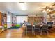 Bright community library with bookshelves, tables, chairs, and an exit to the exterior at 5538 Antigua Dr, Zephyrhills, FL 33541