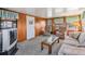 Cozy living room featuring paneled walls and traditional furniture at 5538 Antigua Dr, Zephyrhills, FL 33541