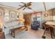 Relaxing living room features a soft couch, accent chair, and a small desk area for work at 5538 Antigua Dr, Zephyrhills, FL 33541