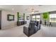Well-lit game room with comfortable seating, TV, and a foosball table at 5636 Silver Moonlight Dr, Palmetto, FL 34221