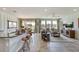 Open-concept living room featuring modern decor, ample natural light, and a view to the outside at 5636 Silver Moonlight Dr, Palmetto, FL 34221