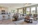 Open concept living room with kitchen, dining area, and outside views at 5636 Silver Moonlight Dr, Palmetto, FL 34221