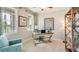 Bright office space with two windows, a desk, an accent chair, and a bookshelf at 5636 Silver Moonlight Dr, Palmetto, FL 34221