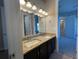 View of a bathroom featuring double sinks with a granite countertop and a large mirror at 5927 Churchside Dr, Lithia, FL 33547