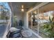 Inviting screened patio with view of the home's interior through sliding glass doors at 5970 Grand Sonata Ave, Lutz, FL 33558