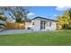 This home's backyard features a green lawn, wood fence, patio, and an exterior wall at 6326 22Nd N Ave, St Petersburg, FL 33710