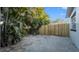 Home's backyard featuring a stone paver patio, wood fence, and lush greenery at 6326 22Nd N Ave, St Petersburg, FL 33710