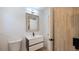 Modern bathroom with vanity sink, updated fixtures, wood tiled wall and a toilet at 6326 22Nd N Ave, St Petersburg, FL 33710