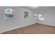 Bright bedroom with two windows and luxury vinyl plank flooring at 6326 22Nd N Ave, St Petersburg, FL 33710