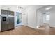 Open entryway features luxury vinyl plank flooring, stainless fridge and direct access to backyard at 6326 22Nd N Ave, St Petersburg, FL 33710