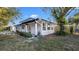 A charming home featuring black trim, white exterior, and a well-manicured front yard at 6326 22Nd N Ave, St Petersburg, FL 33710