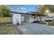 Home exterior featuring a covered parking area with a black trimmed roof and an attached carport at 6326 22Nd N Ave, St Petersburg, FL 33710