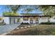 Charming one story house with a carport, black and white trim, and front yard landscaping at 6326 22Nd N Ave, St Petersburg, FL 33710