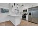 Open white kitchen with stainless steel appliances, stone countertops and hardwood floors at 6326 22Nd N Ave, St Petersburg, FL 33710