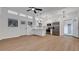 Bright, open-concept living room with white walls, ceiling fan, hardwood floors and kitchen at 6326 22Nd N Ave, St Petersburg, FL 33710