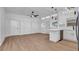 Bright living room with hardwood floors, white walls, modern kitchen, and ceiling fan at 6326 22Nd N Ave, St Petersburg, FL 33710