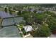 Overhead view of tennis courts and a charming clubhouse surrounded by lush greenery and mature trees at 724 Winterside Dr, Apollo Beach, FL 33572