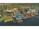 Expansive aerial view of waterfront community featuring pool, clubhouse, dock, and lush tropical landscaping at 724 Winterside Dr, Apollo Beach, FL 33572