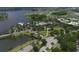 Beautiful aerial view of a lakeside community with lush greenery, a pool, walking paths, and well-maintained roads at 724 Winterside Dr, Apollo Beach, FL 33572