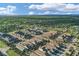 An aerial view shows a residential neighborhood bordered by a lush, expansive green space under a bright, partly cloudy sky at 724 Winterside Dr, Apollo Beach, FL 33572