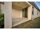 Covered back patio featuring concrete flooring and sliding glass door entry into the home at 724 Winterside Dr, Apollo Beach, FL 33572