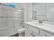 Bathroom features white cabinets, brushed silver hardware, and a glass-enclosed tub and shower at 724 Winterside Dr, Apollo Beach, FL 33572