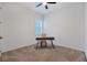 Bedroom with gray carpet, ceiling fan, window with shutters, and a study desk at 724 Winterside Dr, Apollo Beach, FL 33572