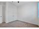 Neutral-toned bedroom featuring gray carpet and a double-door closet with silver hardware at 724 Winterside Dr, Apollo Beach, FL 33572