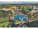 An aerial view of the community amenities including a pool, a water slide and docks next to a beautiful lake and clubhouse at 724 Winterside Dr, Apollo Beach, FL 33572