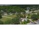 Aerial view showcases the community park, walkways, landscaping, and winding street with water and woods in the distance at 724 Winterside Dr, Apollo Beach, FL 33572