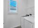 Laundry room with a side by side washer and dryer, white walls, and a window with shutters at 724 Winterside Dr, Apollo Beach, FL 33572