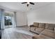 Open concept living room with modern sliding doors leading to an outdoor space and grey tile flooring at 724 Winterside Dr, Apollo Beach, FL 33572
