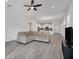 Open-concept living room featuring an open floor plan, grey tile flooring, and neutral decor at 724 Winterside Dr, Apollo Beach, FL 33572