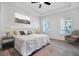 Bedroom with a tray ceiling, plantation shutters, and elegant bedside table lamps at 724 Winterside Dr, Apollo Beach, FL 33572