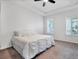 Bedroom with a tray ceiling, plush carpet, and plantation shutters at 724 Winterside Dr, Apollo Beach, FL 33572