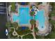 Aerial view of a large community pool featuring lap lanes, a area, and lush landscaping with palm trees at 724 Winterside Dr, Apollo Beach, FL 33572