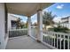 The covered porch has white railings and columns, offering a relaxing outdoor space with views of the neighborhood at 724 Winterside Dr, Apollo Beach, FL 33572