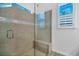 Shower featuring a glass door, tiled walls, and a built-in bench at 724 Winterside Dr, Apollo Beach, FL 33572