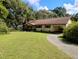 Charming single-story home with a well-manicured lawn and a long driveway at 7608 Chenkin, Zephyrhills, FL 33540