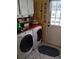 Functional laundry room with washer, dryer, storage, and a stylish, patterned floor at 7608 Chenkin, Zephyrhills, FL 33540