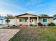 Charming single-story home with well-maintained landscaping, driveway, and inviting front porch at 8139 38Th N Ave, St Petersburg, FL 33710