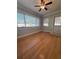 Bright living room featuring gleaming hardwood floors and abundant natural light from the windows at 8139 38Th N Ave, St Petersburg, FL 33710