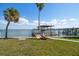 Waterfront dock featuring a covered boat lift, and open access to the bay at 901 Bay Esplanade, Clearwater Beach, FL 33767